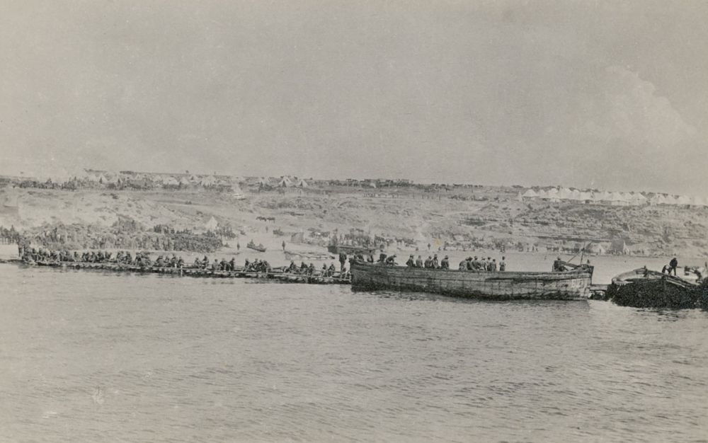 Troops from Australian and New Zealand infantry brigades about to embark at W Beach to return to ANZAC Cove.